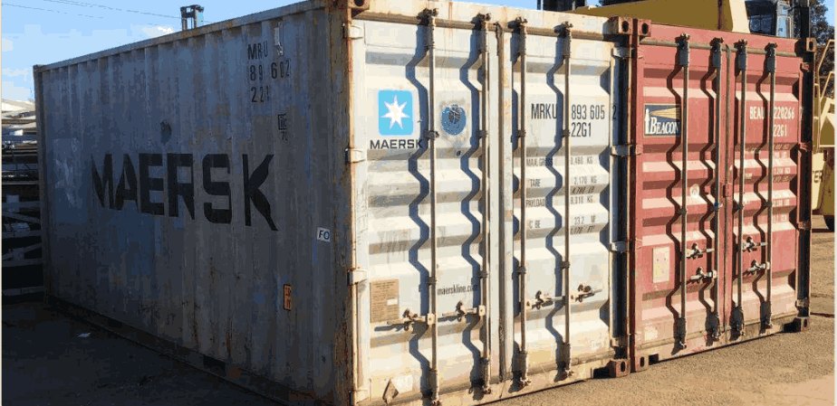 Shipping containers stacked in an outdoor yard.