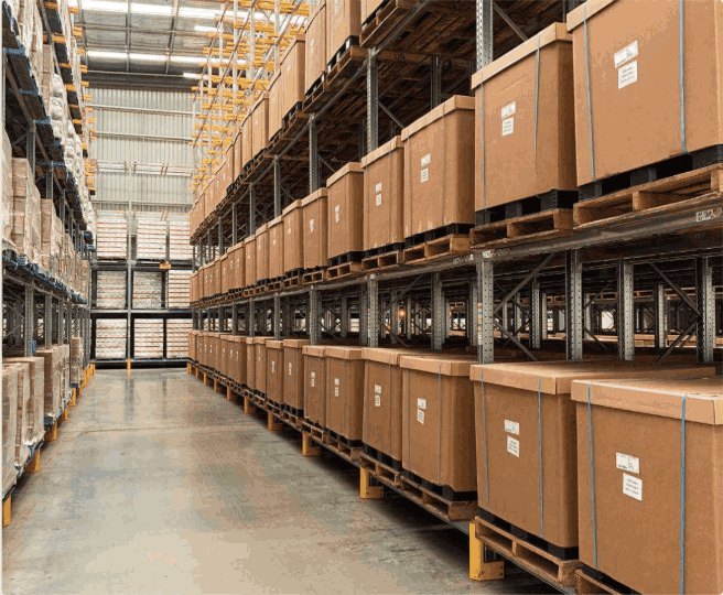 Cartons on timber pallets stored in multi-level warehouse racking.